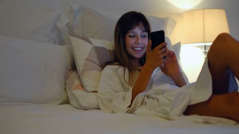 woman using mobile on bed in bedroom at home 4k