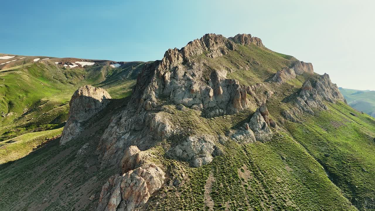 Breathtaking aerial view of rocky mountain under clear blue sky