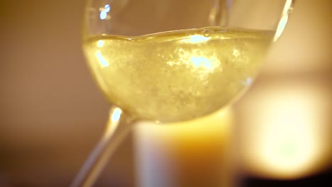 close up of pouring champagne into glass in slow motion