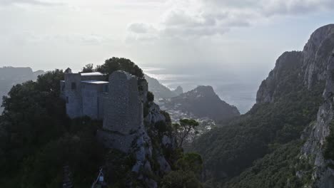 ancient fortress on capri's cliffs overlooking the sea with clouds