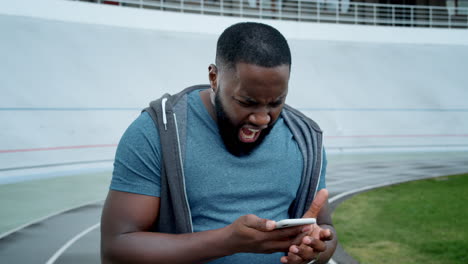 sad man using mobile phone outdoors
