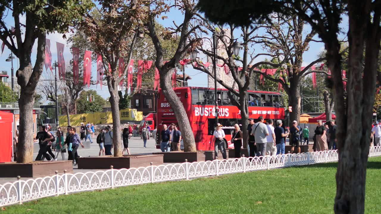 A street scene with a double-decker bus and people