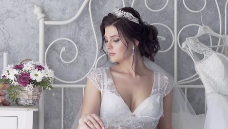 slow motion pretty young woman in white looks at flowers