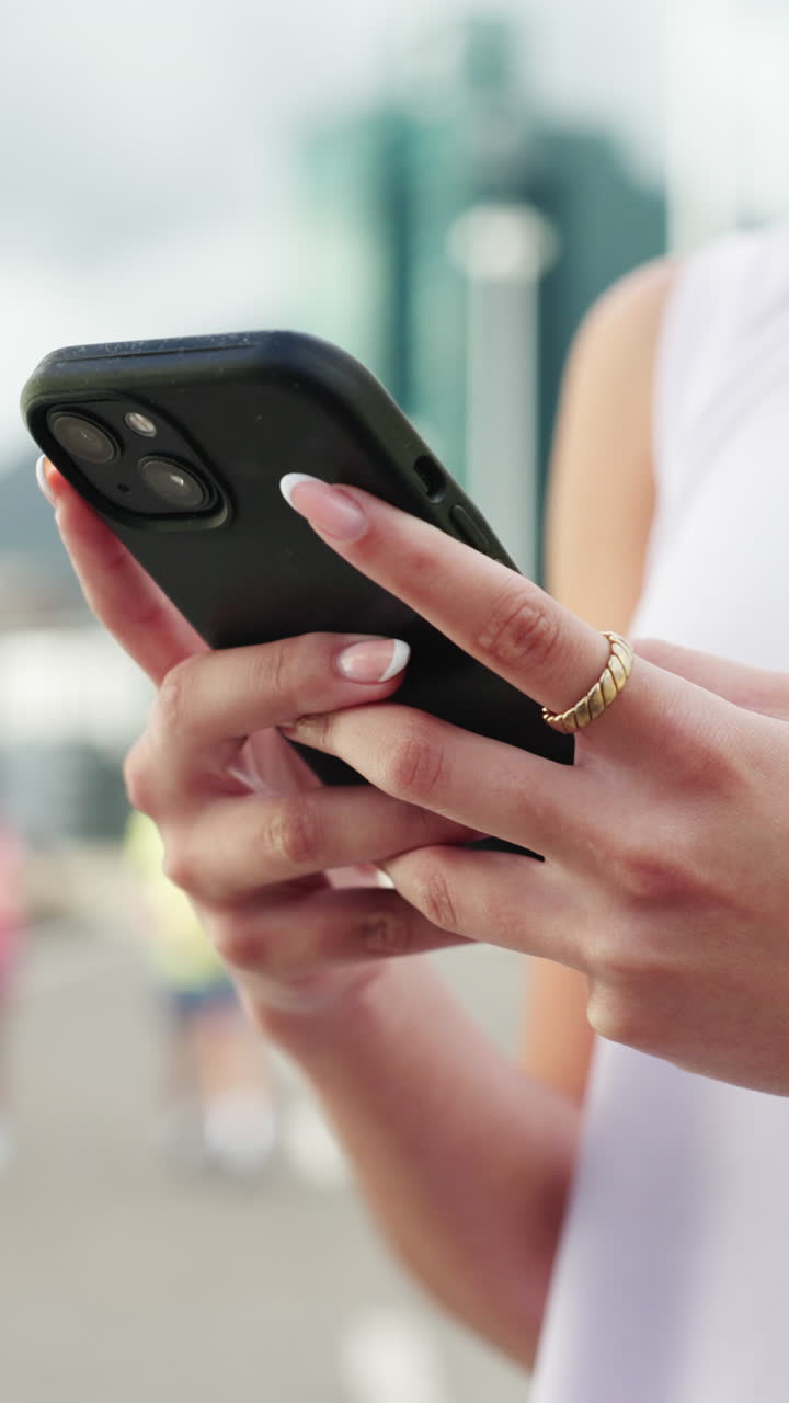 Close-up of Woman's Hands Using Smartphone Outdoors