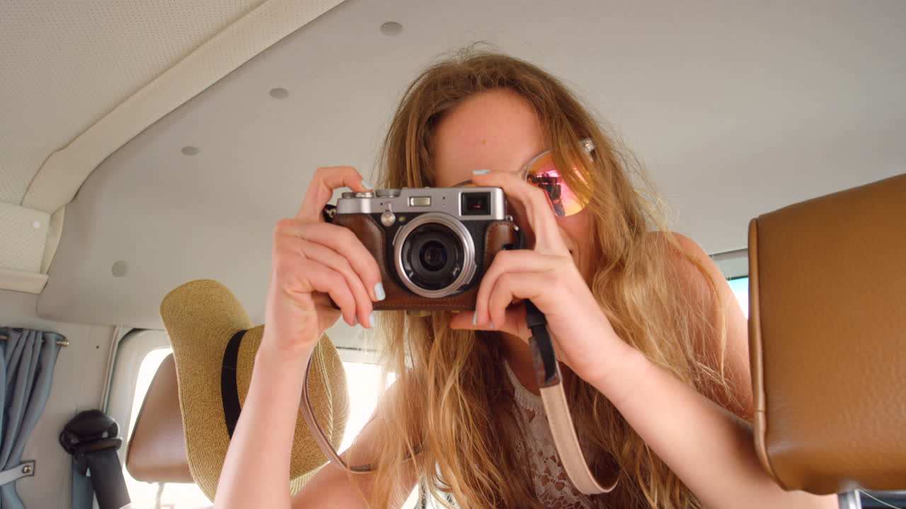 Happy young woman posing while taking photos