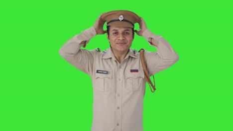 happy indian police officer wearing hat green screen