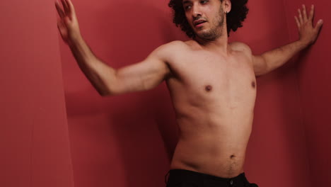 young man dancing in a red room