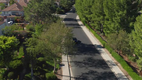 Aerial-view-of-a-car-driving-through-a-neighborhood-in-Mission-Viejo,-California