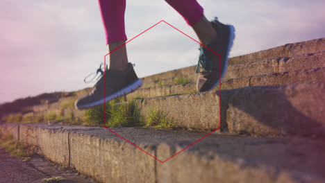 red hexagonal shape against low section of a woman running down the stairs