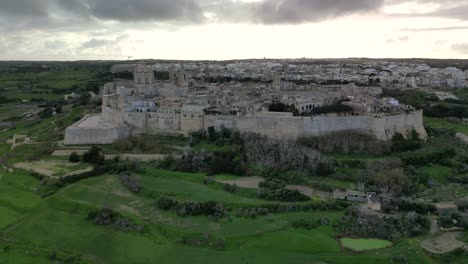 drone video flying towards mdina in malta on a grey cloudy day