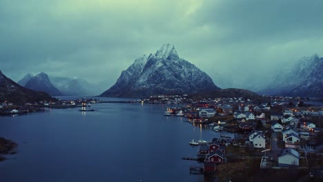 Picturesque-landscape-of-small-town-on-seashore-surrounded-by-massive-mountains