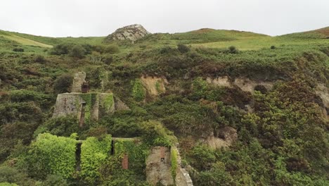 Porth-Wen-aerial-reversing-view-abandoned-Victorian-industrial-chimney-brickwork-factory-remains-on-Anglesey-eroded-coastline