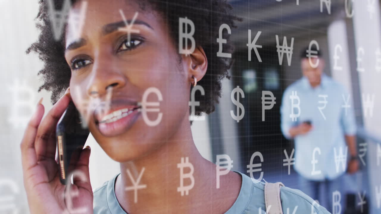 Animation of currency symbols over african american woman talking on smartphone outdoors
