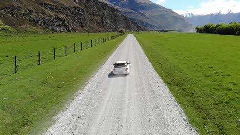 Drone,-aerial-views-of-car-driving-through-mountains-in-New-Zealand