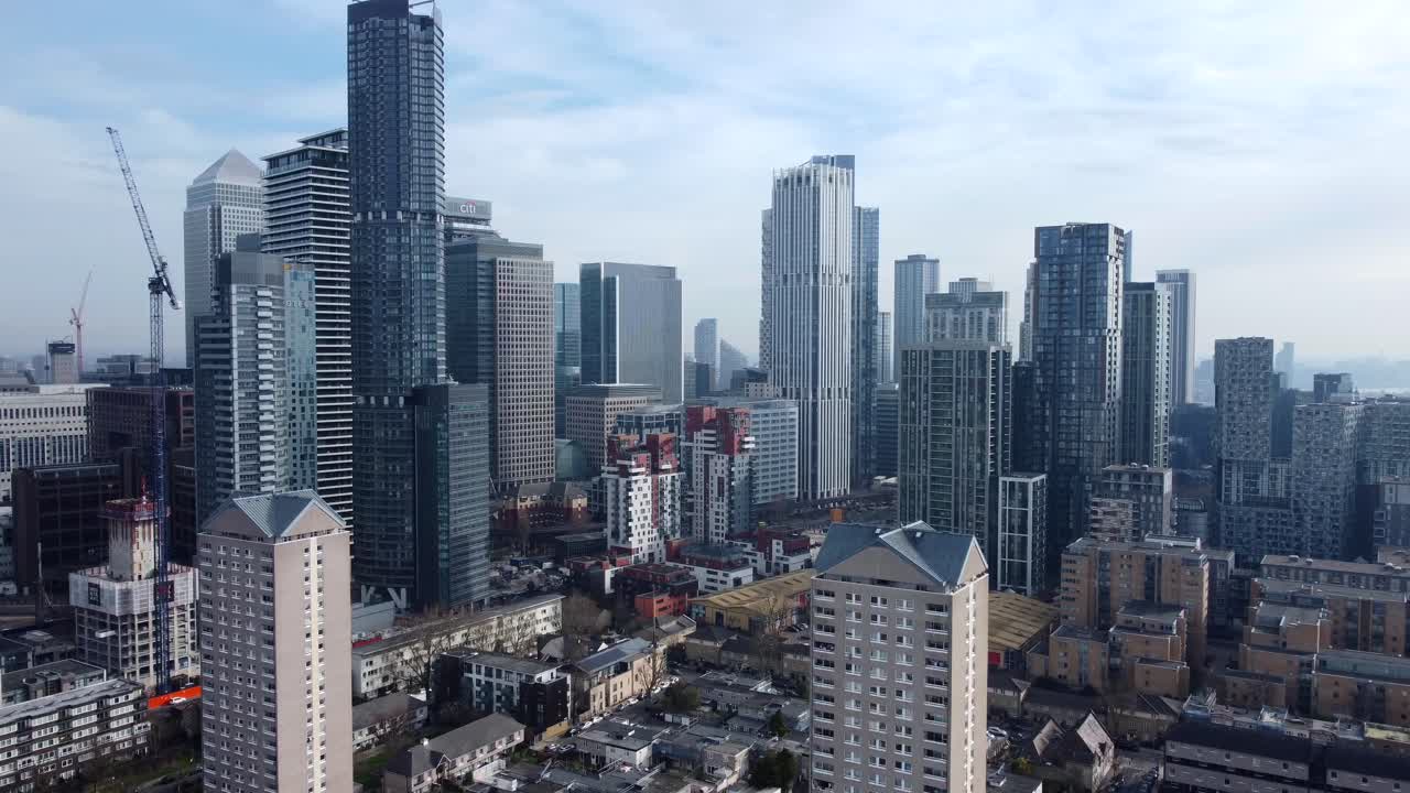 Drone flying forward towards skyscrapers on Canary Wharf skyline