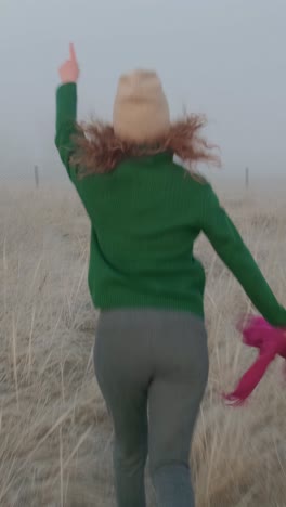 woman running in a foggy field