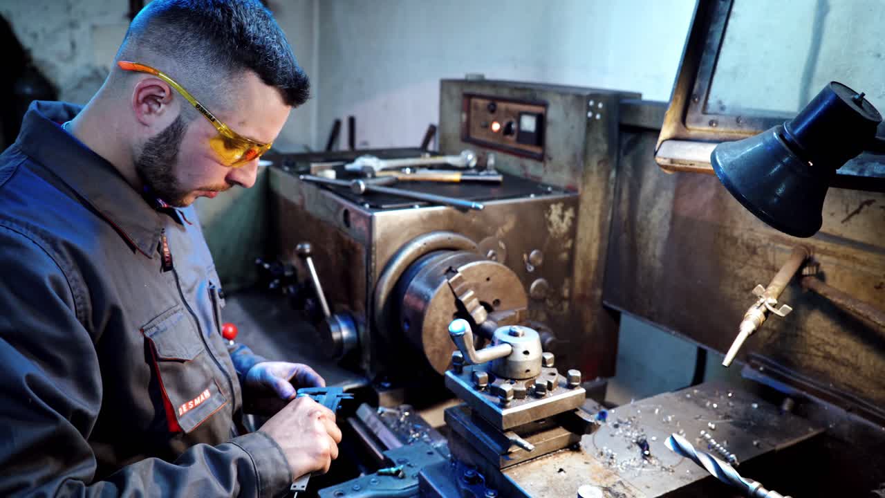 Worker measuring with caliper. Industrial engineering wearing safety clothing using vernier calipers
