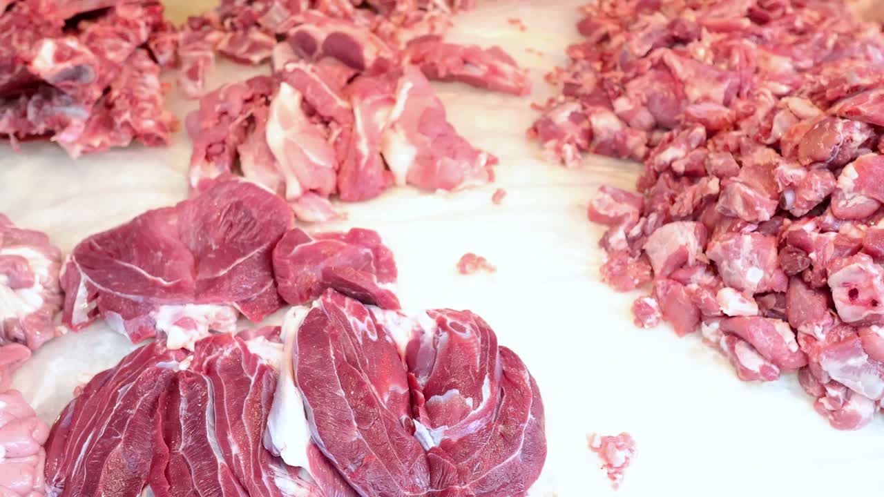 Meat being chopped and spread on a table