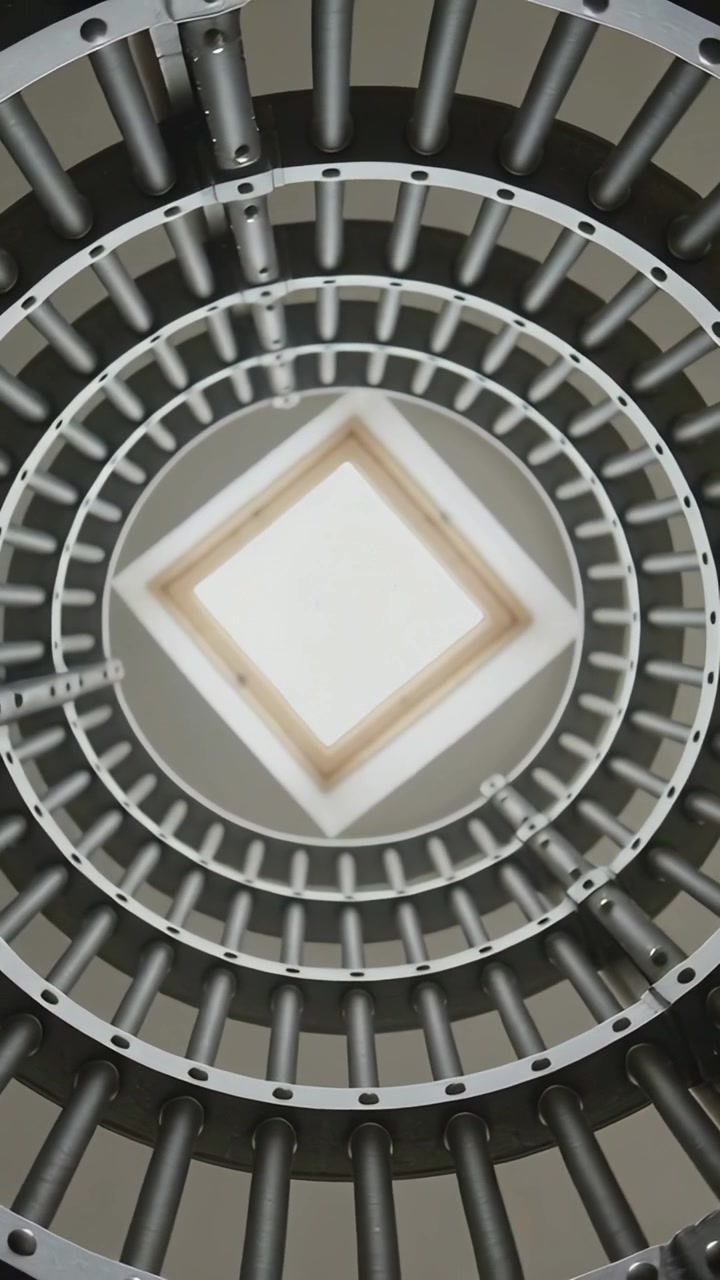 Vertical video: Rotating view showing concentric rings and spokes inside shaft, skylight tilting