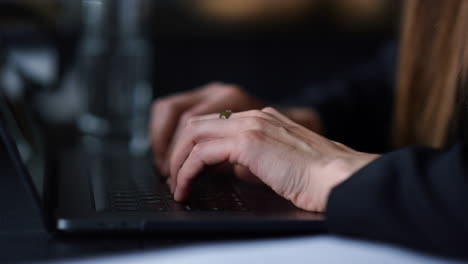 Unrecognizable-woman-hands-typing-on-laptop-computer-at-remote-workplace