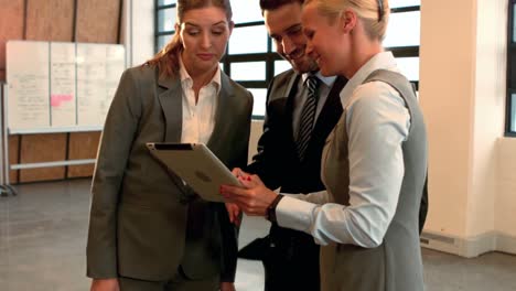 Business-team-looking-at-tablet