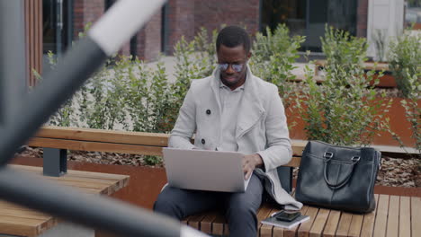 businessman working on laptop outdoors