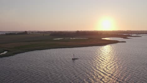 Wide-shot-of-Sail-boat-on-lake-the-fluessen-Friesland-with-soft-light,-aerial