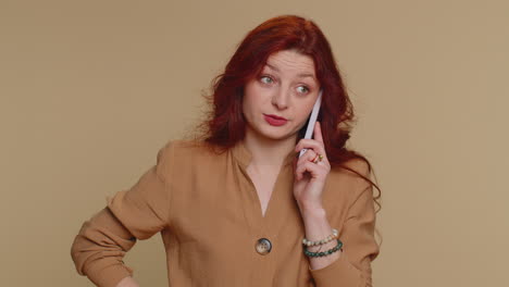 Redhead-woman-tired-sleepy-freelancer-talking-on-mobile-phone-with-friend-making-online-conversation