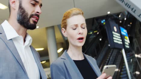 business people discussing over smartphone