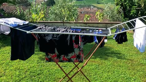 clothes drying on a rack with a picturesque view of a church and lush greenery.