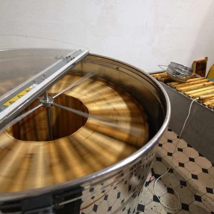 Honey frames rotating in centrifuge. Organic fresh sweet honey harvesting