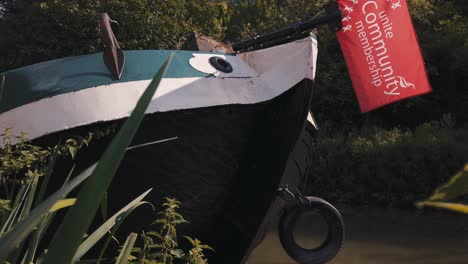 Canal-boat-stern-in-medium-shot-on-a-sunny-day