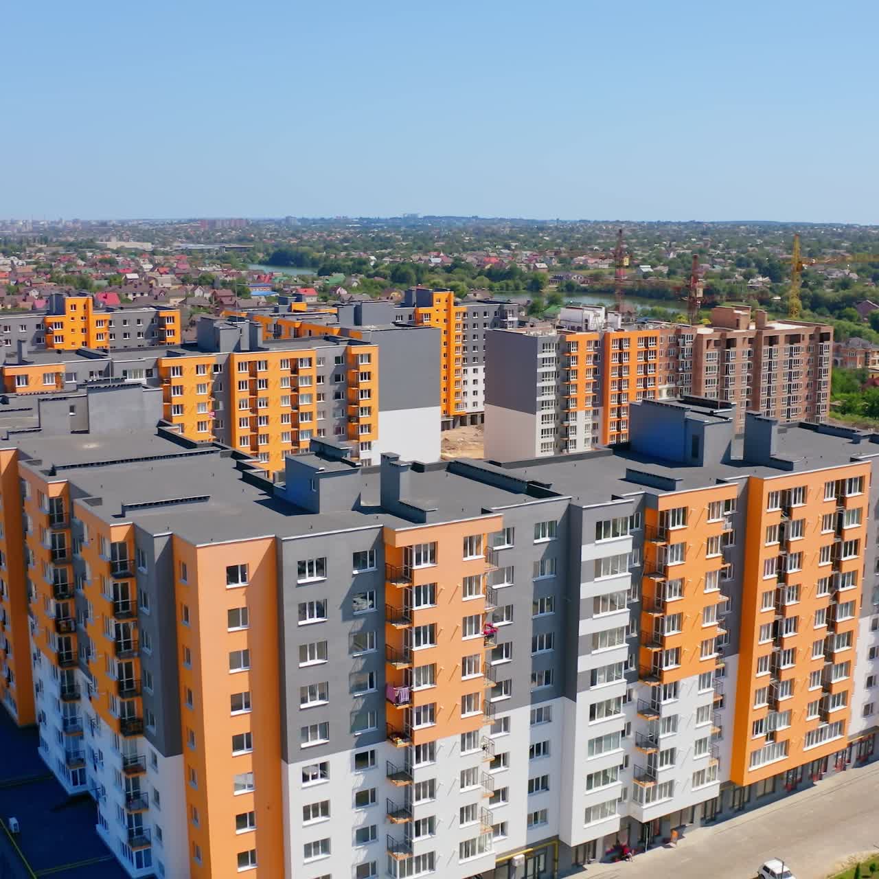 New residential complex with high-rise buildings. Modern multi-storey buildings with colorful walls. Construction site of new residential area at sunlight