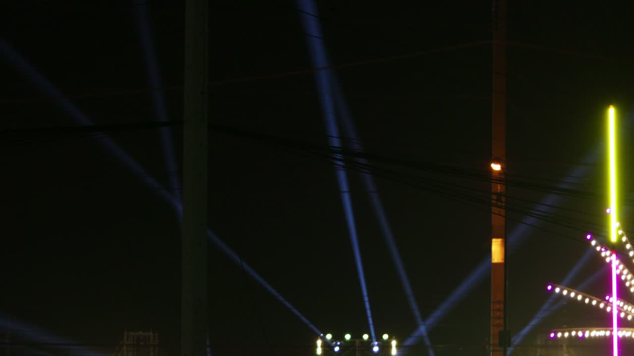 An electrifying light show transforms city skyline into a colorful nighttime spectacle