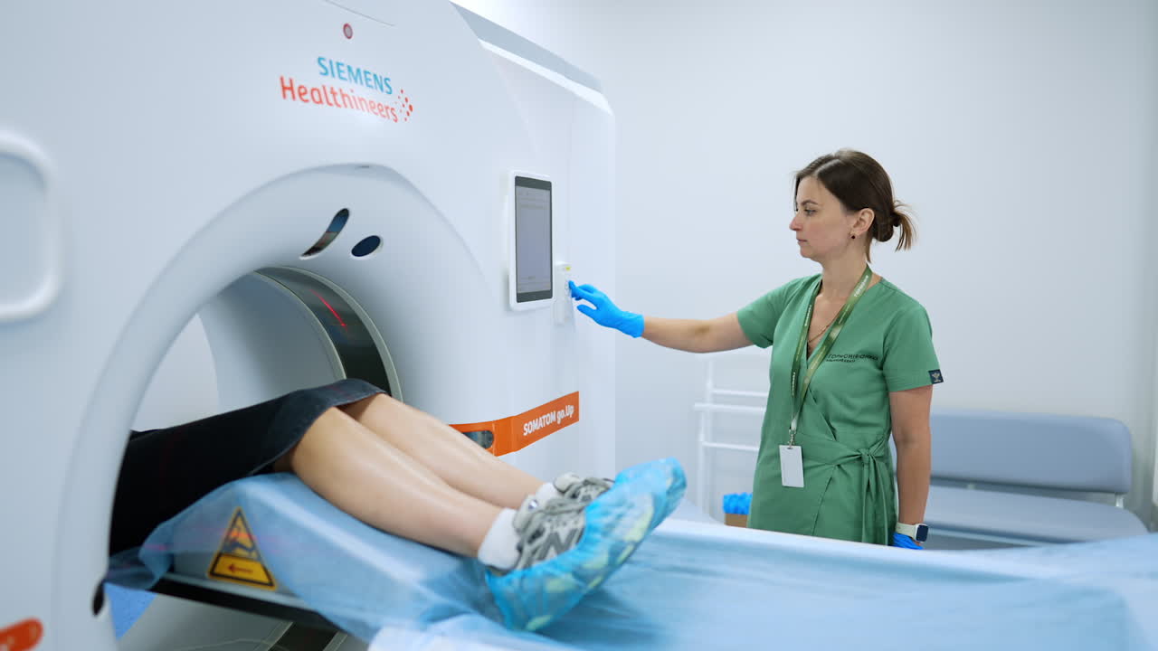 Kyiv, Ukraine, 2 August 2025: CT scan positioning with laser. Technologist aligns patient in CT gantry using red positioning laser beams before imaging