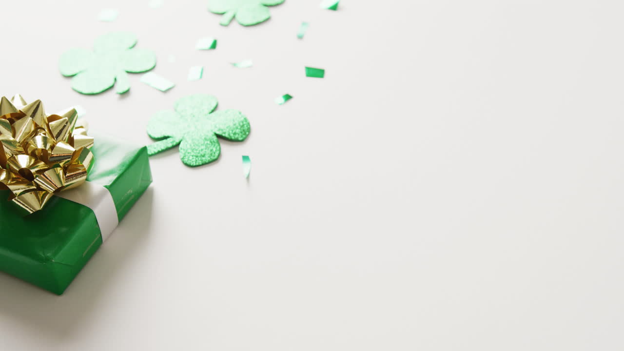 Video di foglie di trifoglio e regalo di San Patrizio con spazio per il testo su sfondo bianco.