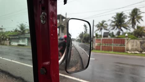 wet road rickshaw tuk tuks cars transport traffic wing mirror view sri lanka south asia