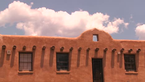 time lapse clouds above a new mexico adobe building