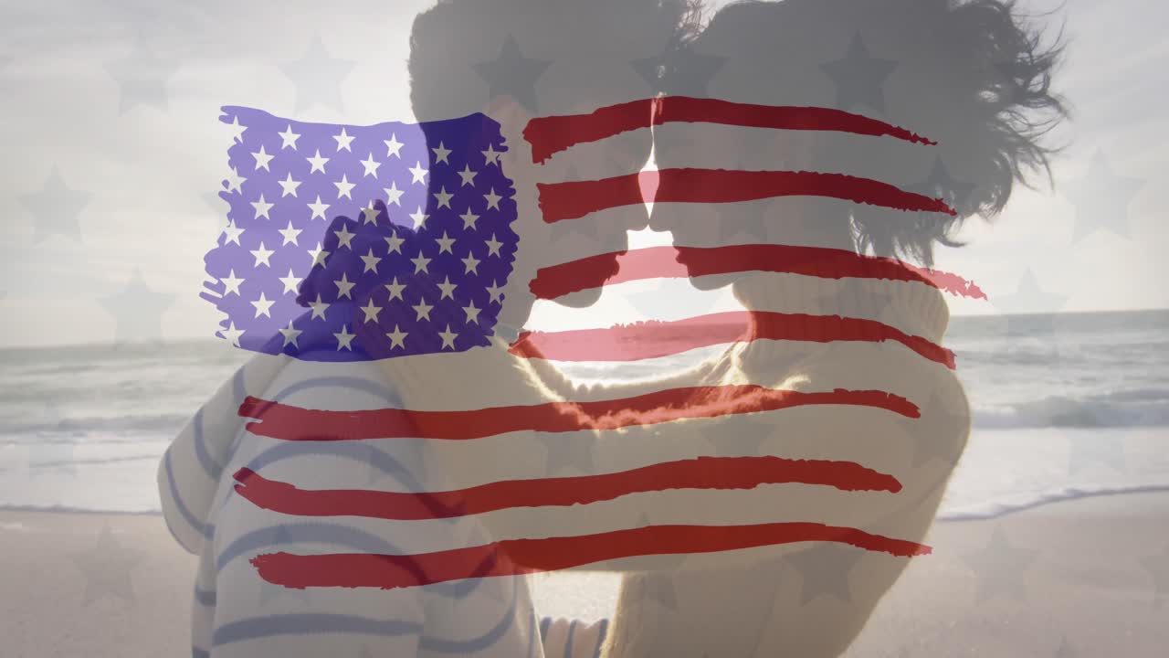 animación de la bandera de los estados unidos de américa sobre una pareja biracial enamorada junto al mar.