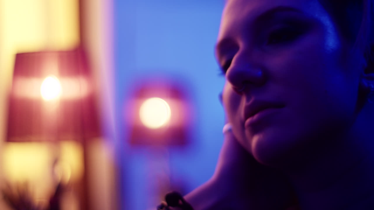 Close-up Portrait of a Woman in a Lit Room