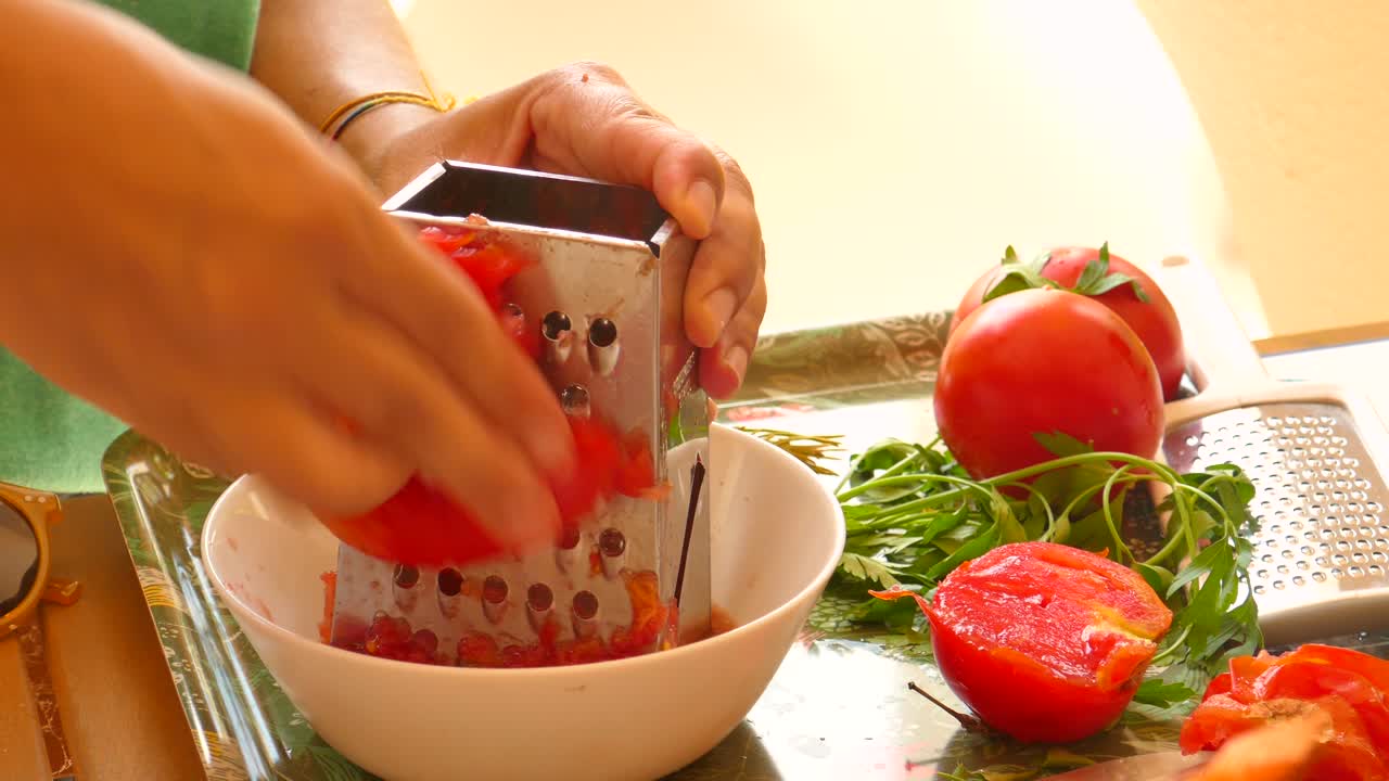 Detail of tomato being grated &amp;quot;sofrito&amp;quot; to prepare traditional Valencian paella sauce