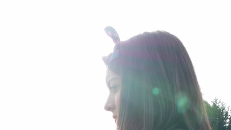 close up of woman standing by a lake