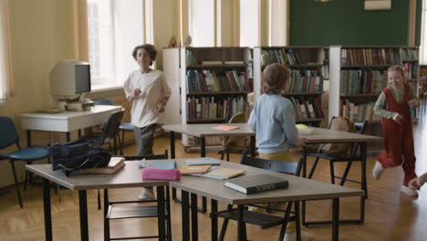 students and an adult interacting happily in a vibrant classroom