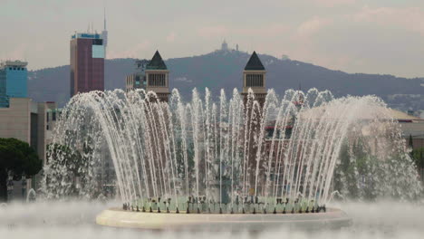 magic fountain of montjuic with venetian towers in background in barcelona, spain. - wide shot