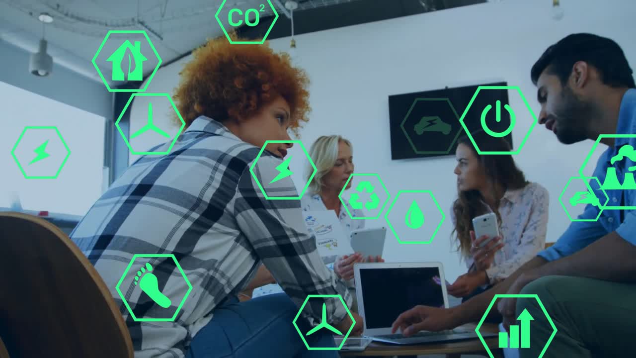 Team gathering around laptop studying environmental data and activating animated green hexagons