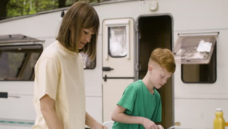 happy family having breakfast at the camping in the forest