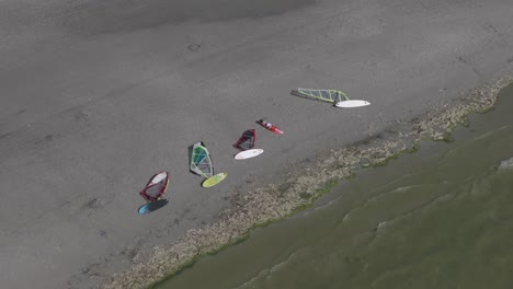 windsurf boards on shore of makkum beach during summer, aerial