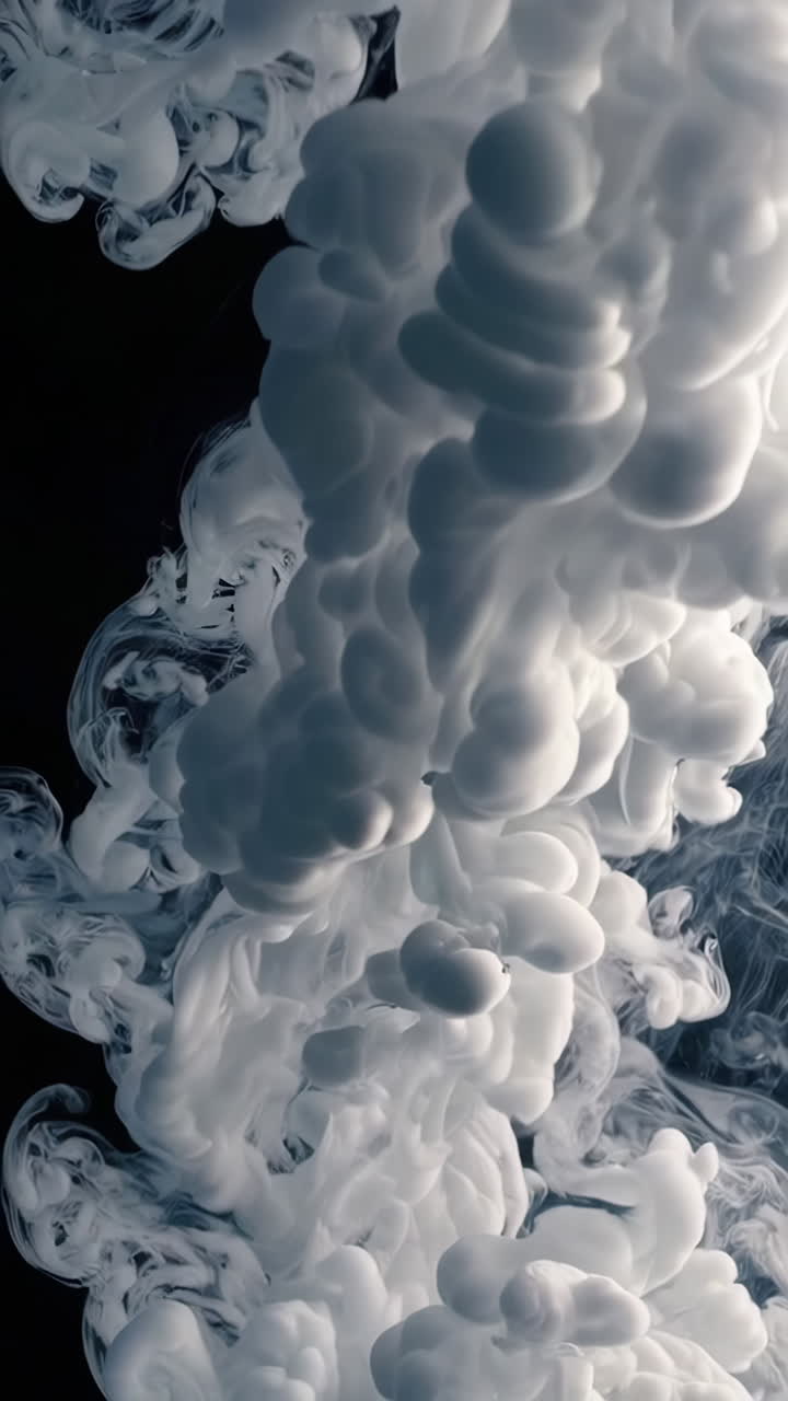 White Ink Plumes or Smoke Effect Against a Dark Background