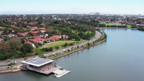 aerial drone shot flying over a boat house with solar panels on the roof, sydney australia