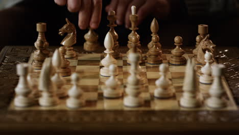 old man hands playing chess